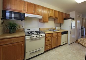 Kitchen with white appliances and wooden cabinets